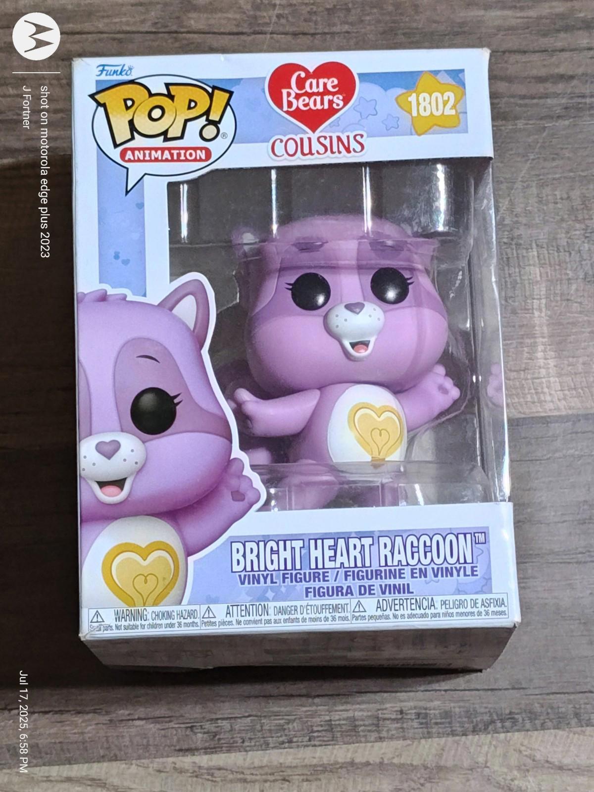 Bright Heart Raccoon vinyl figure from Care Bears, featuring a cute purple design and heart emblem.