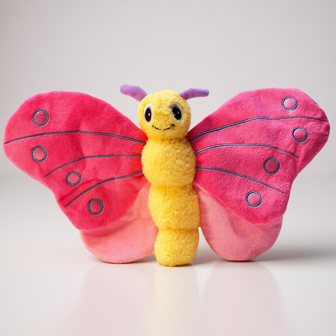 Butterfly plush toy with pink wings and a yellow body, perfect for cuddling.