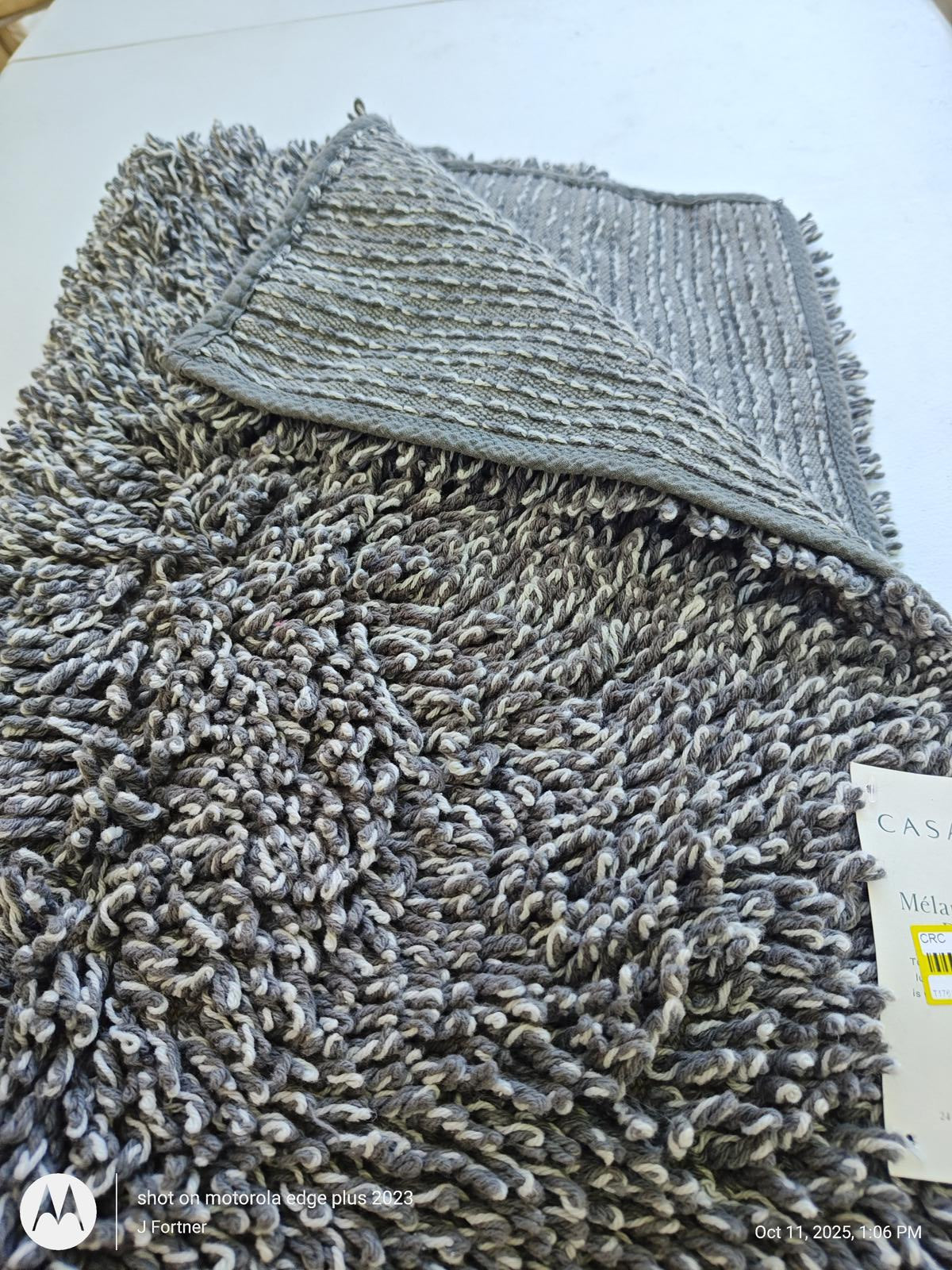 Casablanca plush gray area rug with a soft texture and fringed edges.