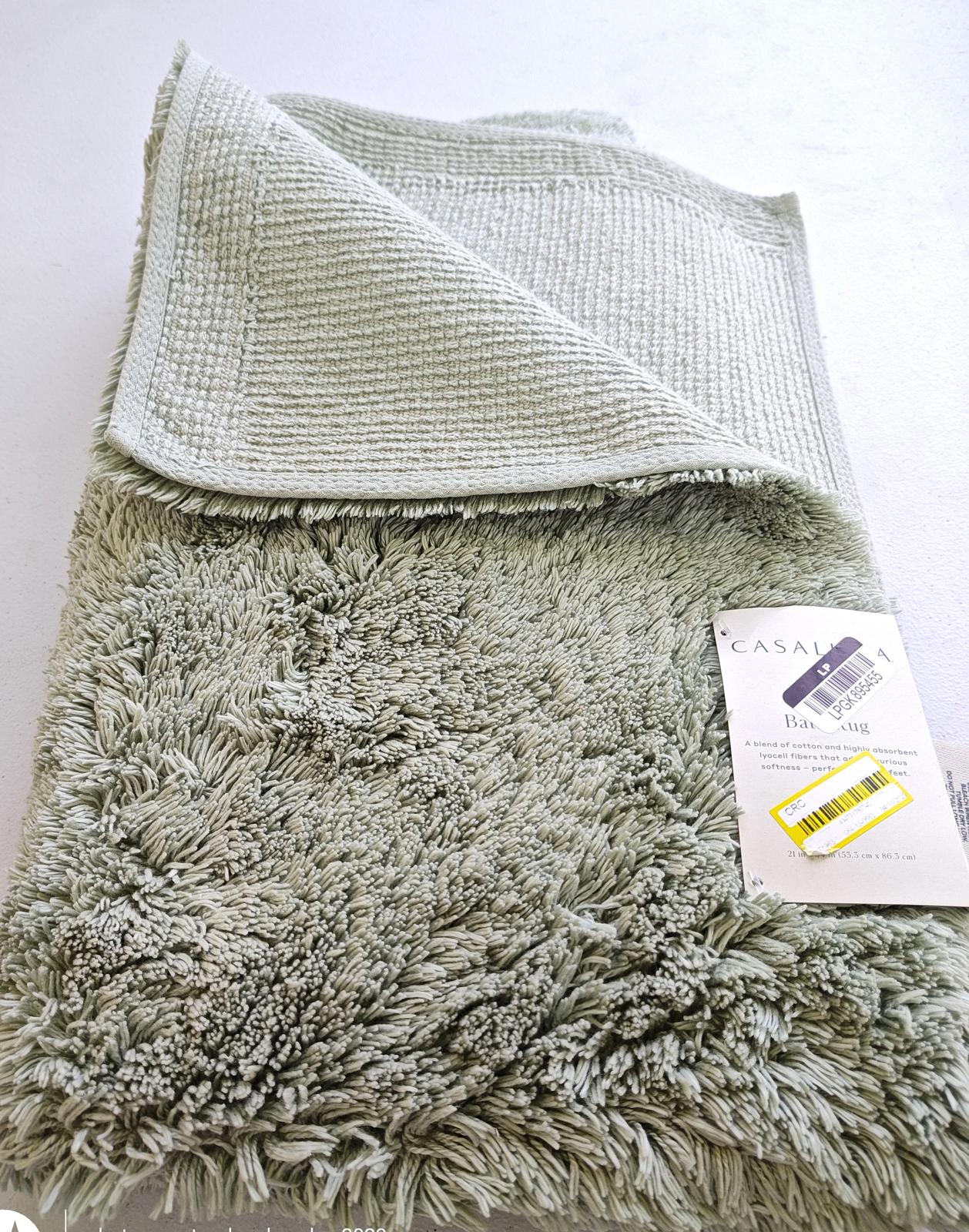 Casaluna plush bath towel in soft green color with textured design.