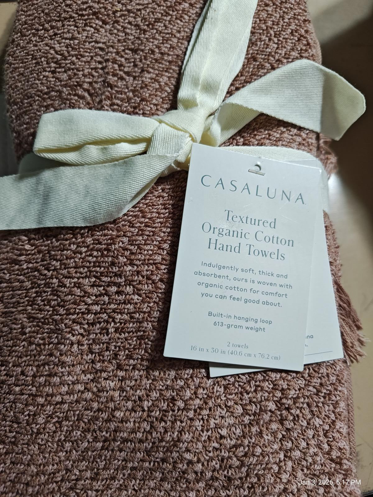 Casaluna textured organic cotton hand towels in soft brown color with a tied ribbon.