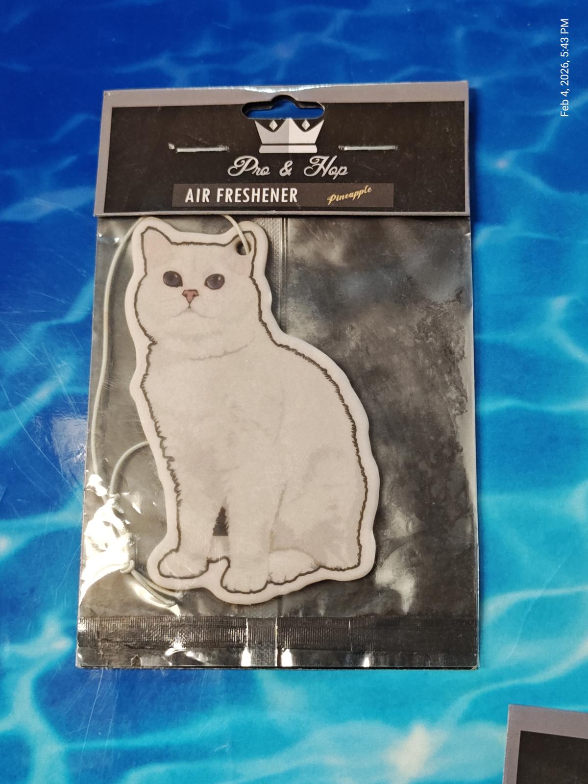 Cat air freshener featuring a white cat design in a hanging package.