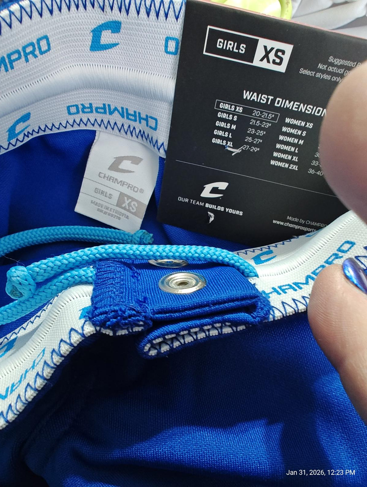 Champ Pro girls XS shorts with blue color and waist dimensions tag visible.
