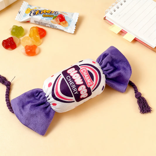 Chaw's Blow Pop Cherry plush toy with purple accents and tassels, surrounded by candy.