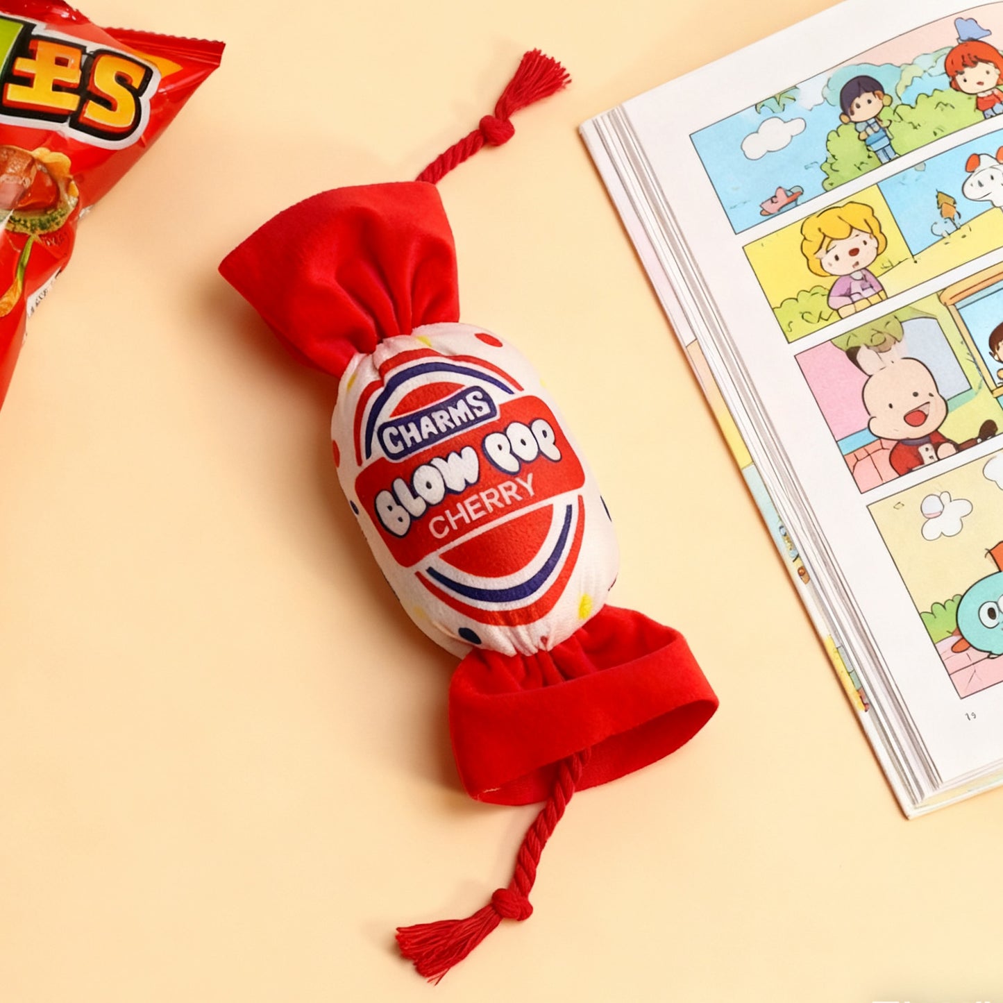 Charms Blow Pop Cherry candy with red wrapper and playful design.