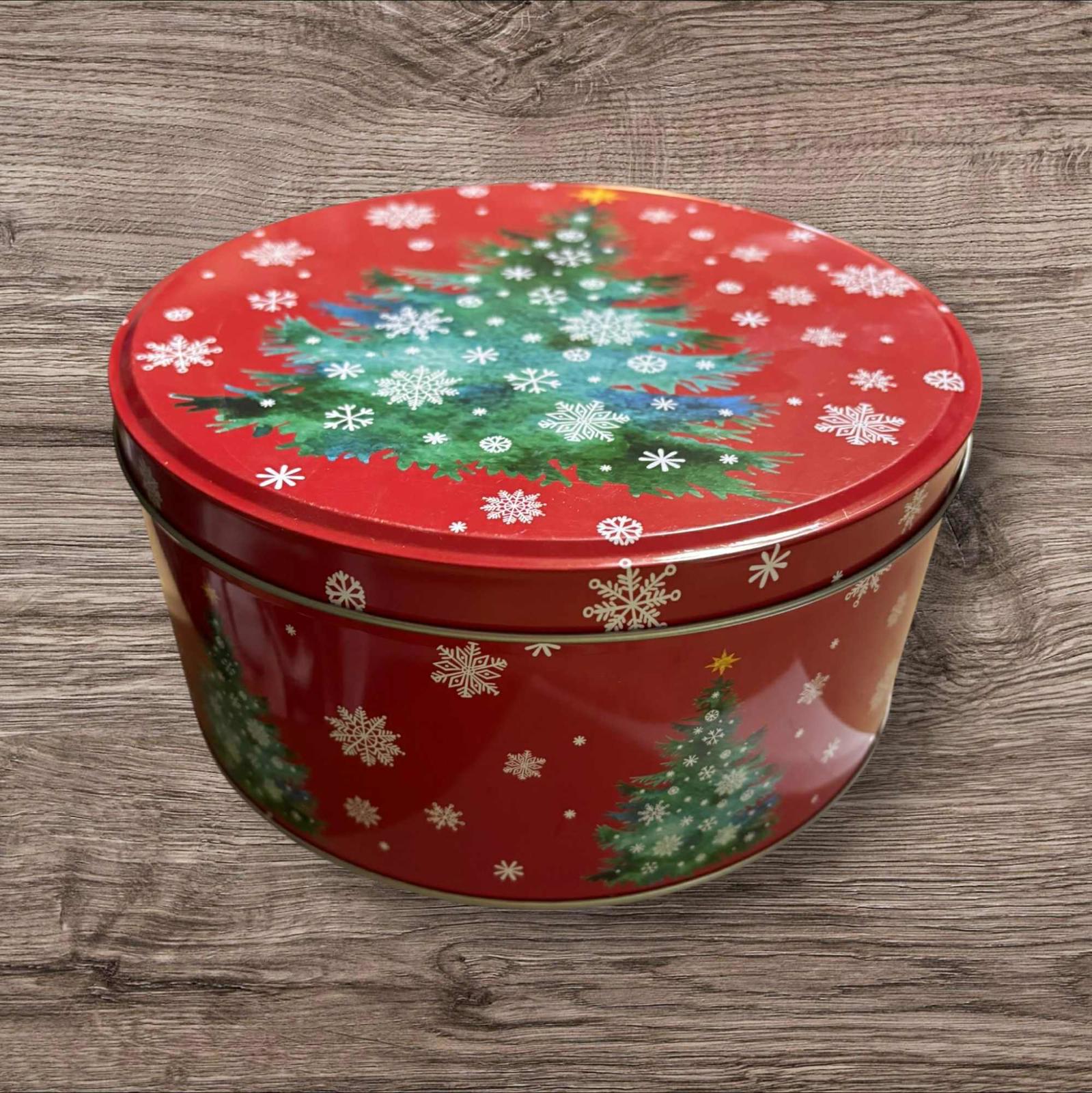Christmas cookie tin featuring a festive red design with Christmas trees and snowflakes.