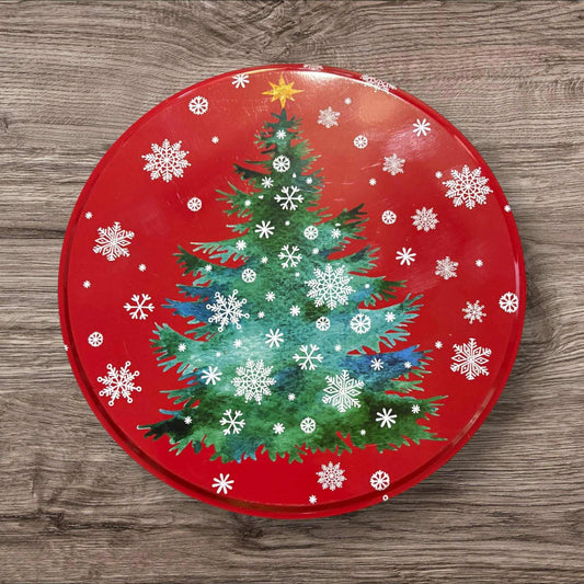 Christmas tree design on a red round tin with snowflakes and stars.