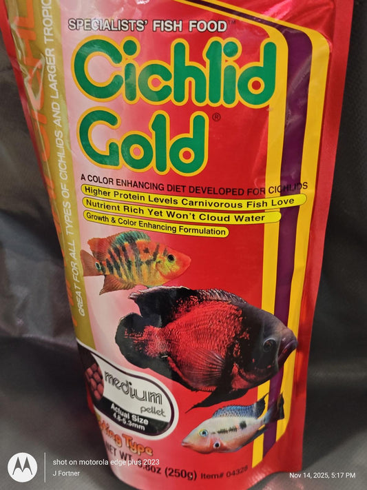 Cichlid Gold fish food packaging featuring colorful fish illustrations and details about its nutrient-rich formula.