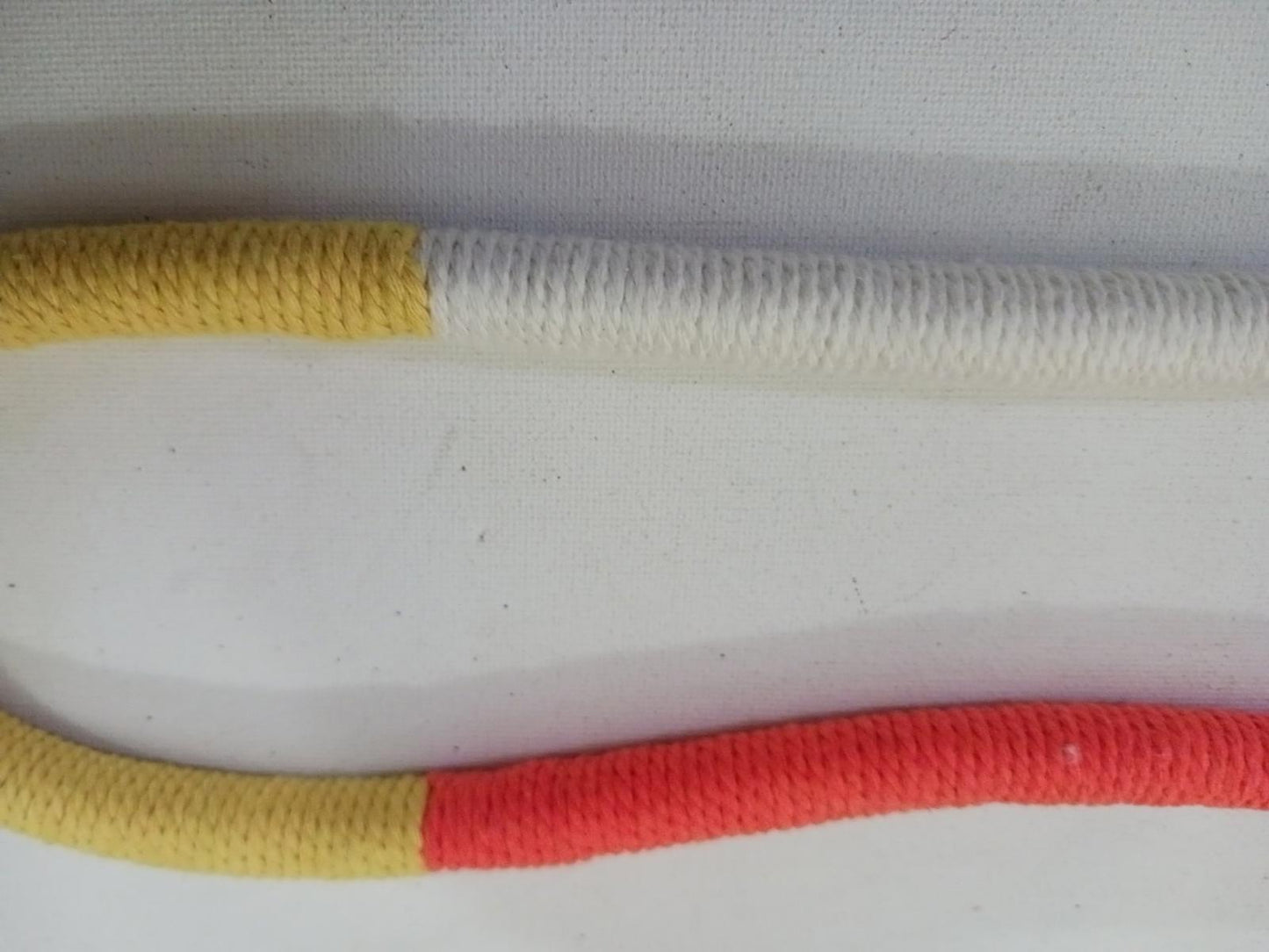 Colorful climbing rope featuring yellow, white, and red sections for enhanced visibility.