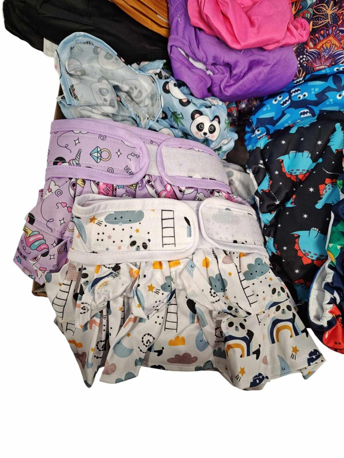 Colorful baby cloth diapers featuring playful animal and cloud designs.