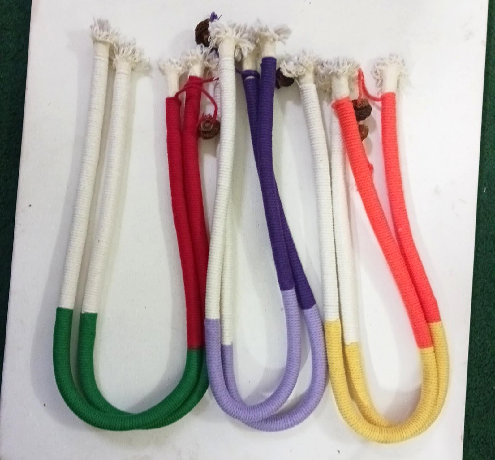 Colorful cotton jump ropes in red, purple, green, and orange for fitness activities.