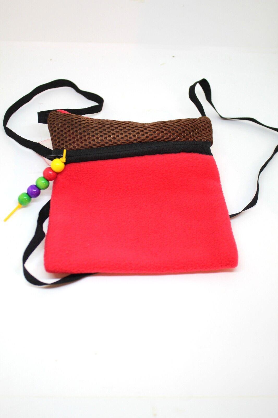 Colorful crossbody bag with a red fleece body and brown mesh top, featuring a beaded zipper pull.