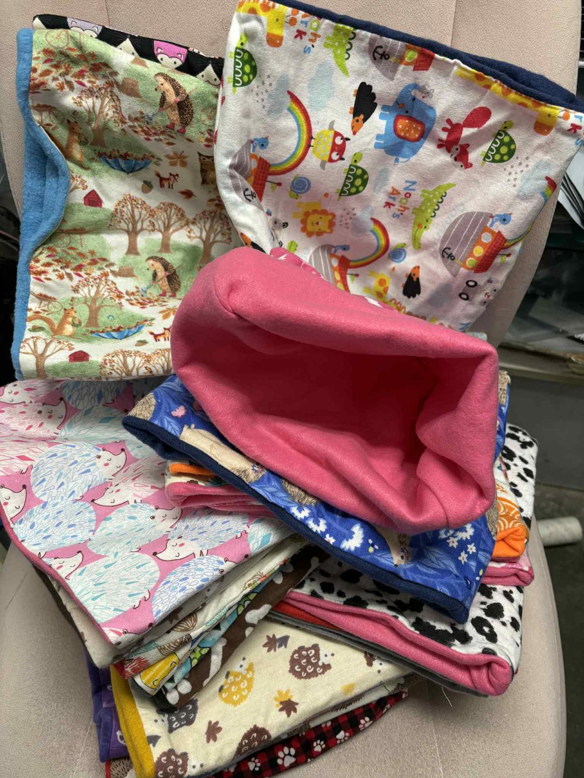 Colorful fabric storage bags featuring various playful patterns and designs.