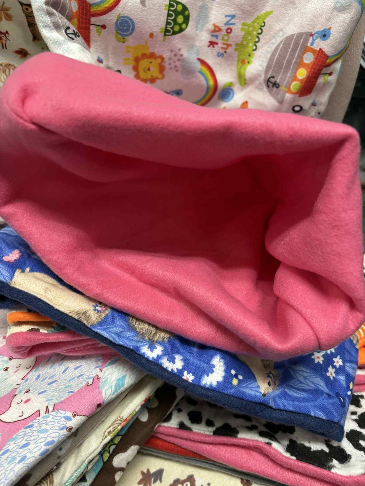 Colorful fabric storage basket with a pink interior and various patterns on the exterior.