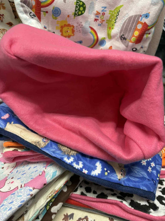 Colorful fabric storage basket with a pink interior and various patterns on the exterior.