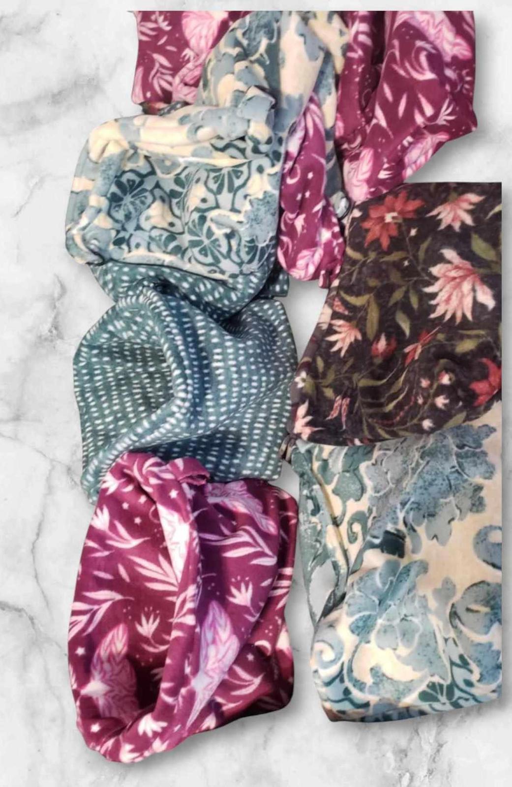 Colorful floral scarf featuring intricate patterns in shades of purple and blue.