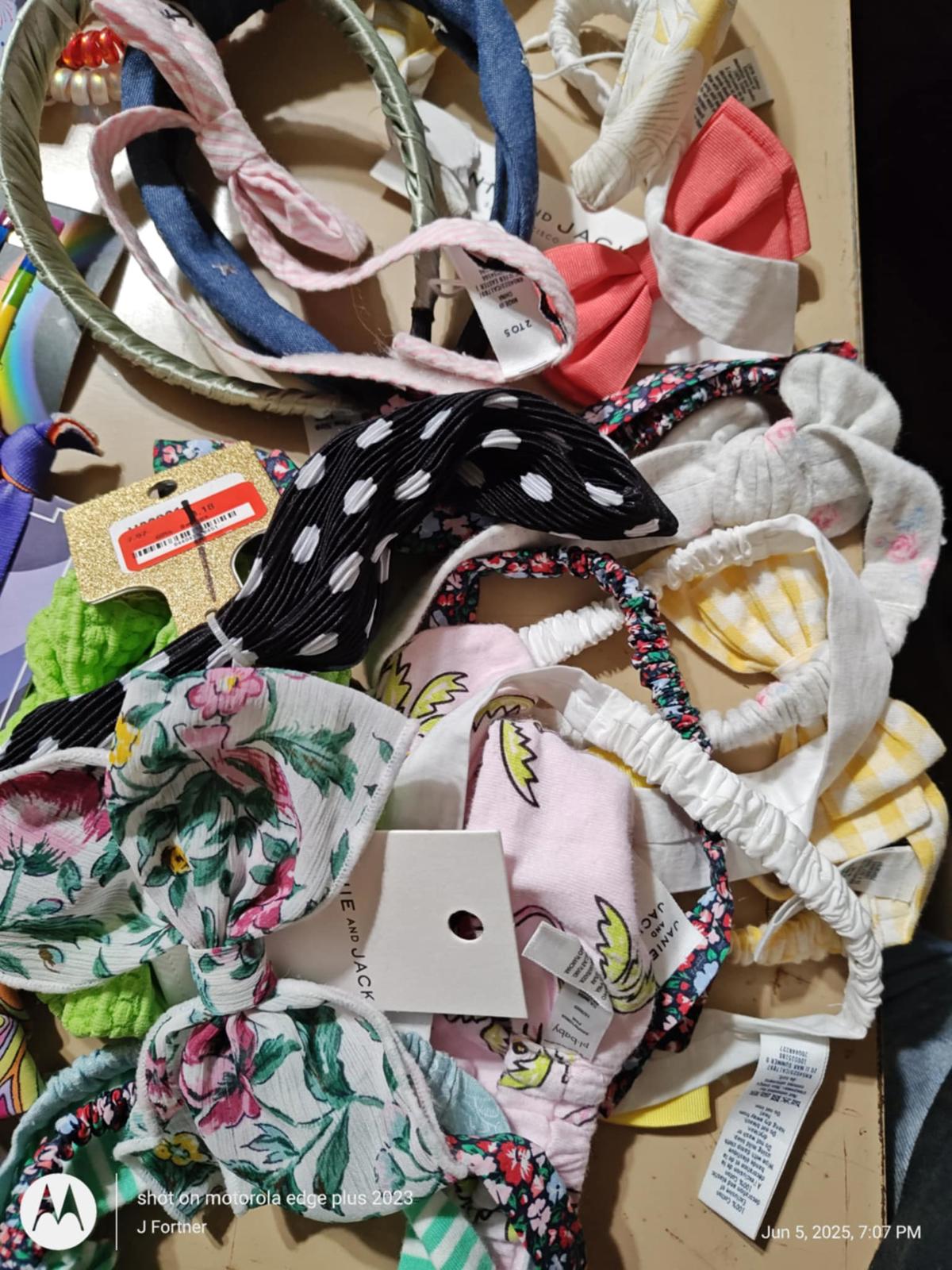 Colorful hair accessories including headbands and bows, featuring floral and polka dot patterns.