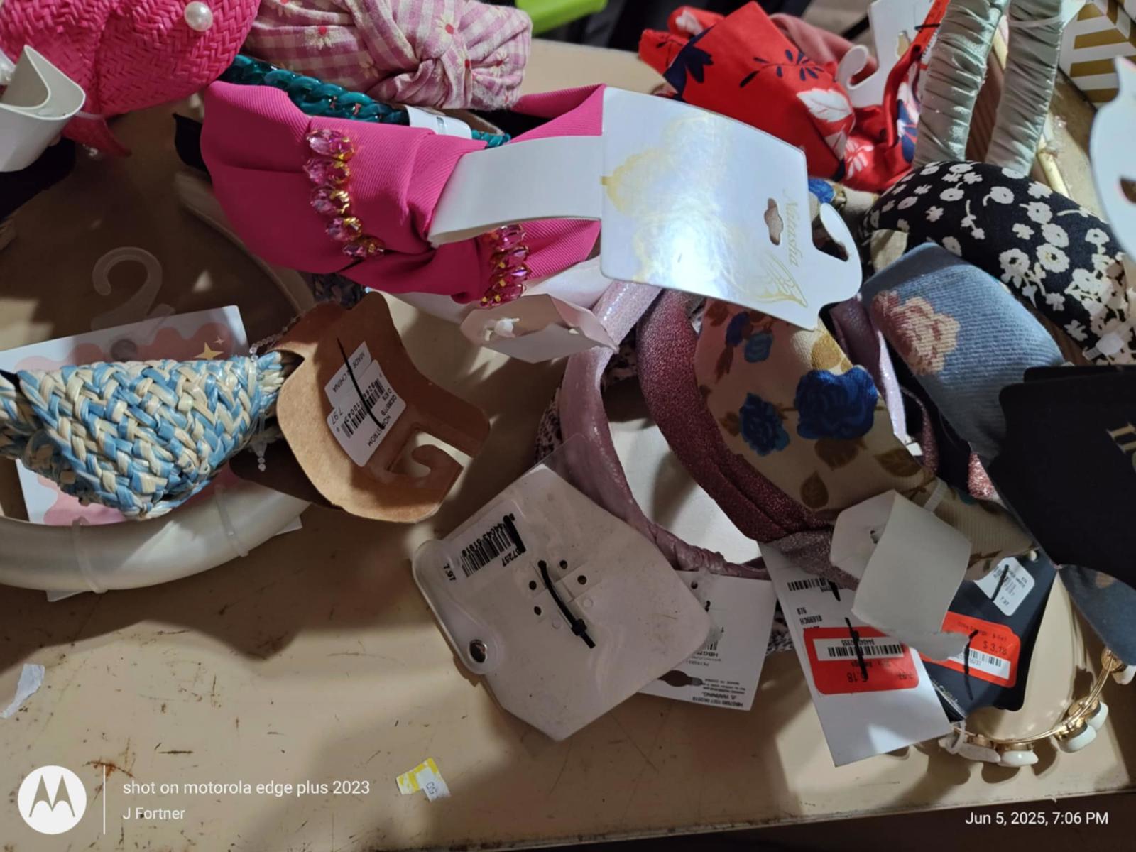 Colorful headbands collection with various designs and tags visible.
