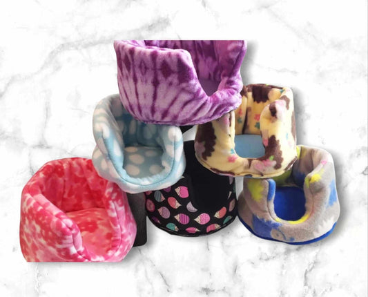 Colorful pet beds featuring various patterns and textures for small animals.