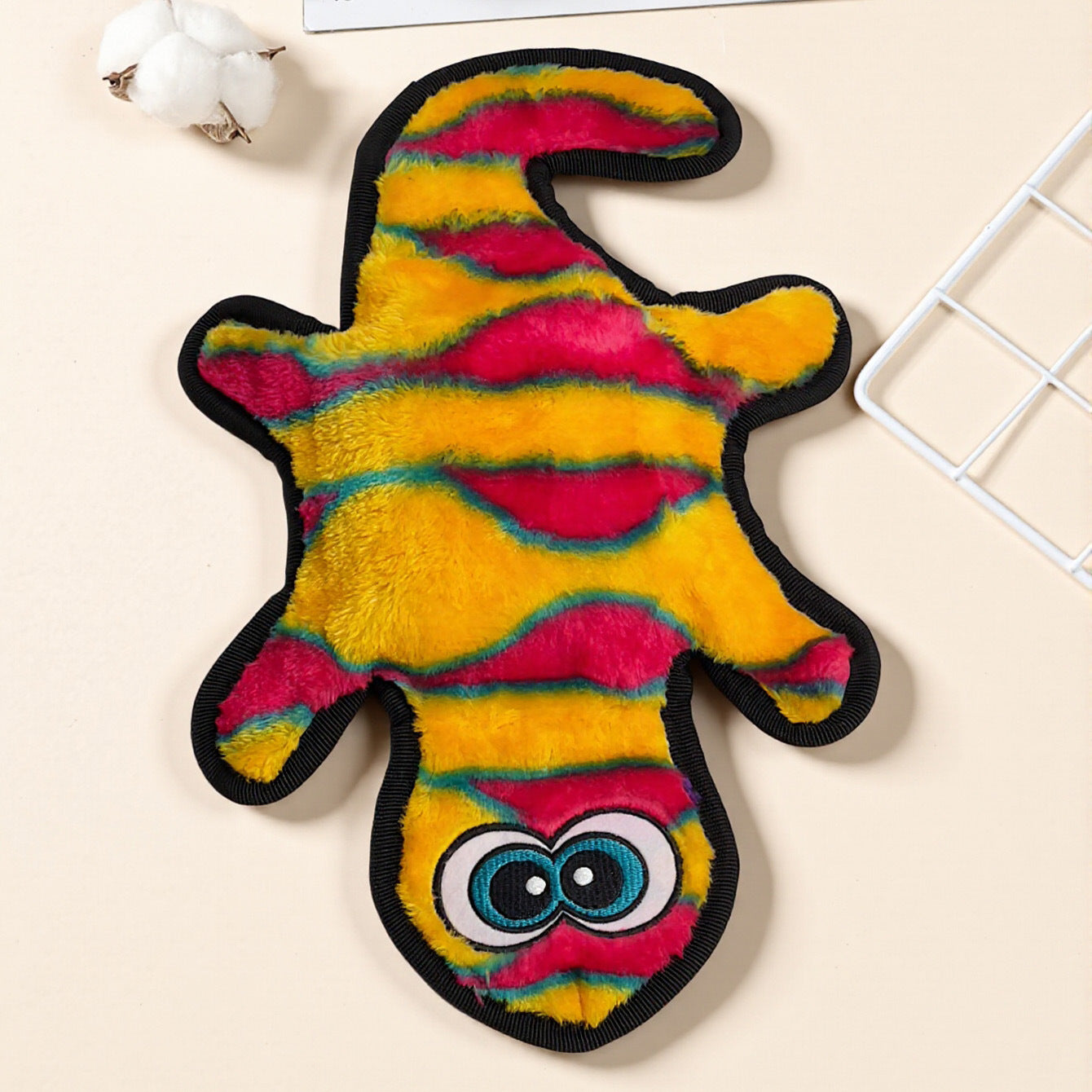 Colorful Plush Monster Toy with vibrant yellow, pink, and green stripes.