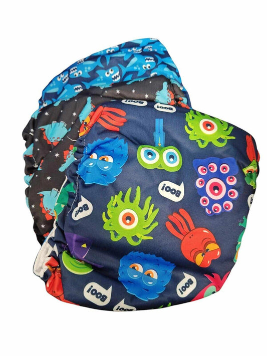 Colorful reusable cloth diapers featuring fun monster designs and vibrant colors.