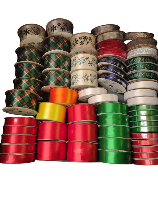 Colorful ribbon assortment featuring red, green, and patterned designs for crafting.
