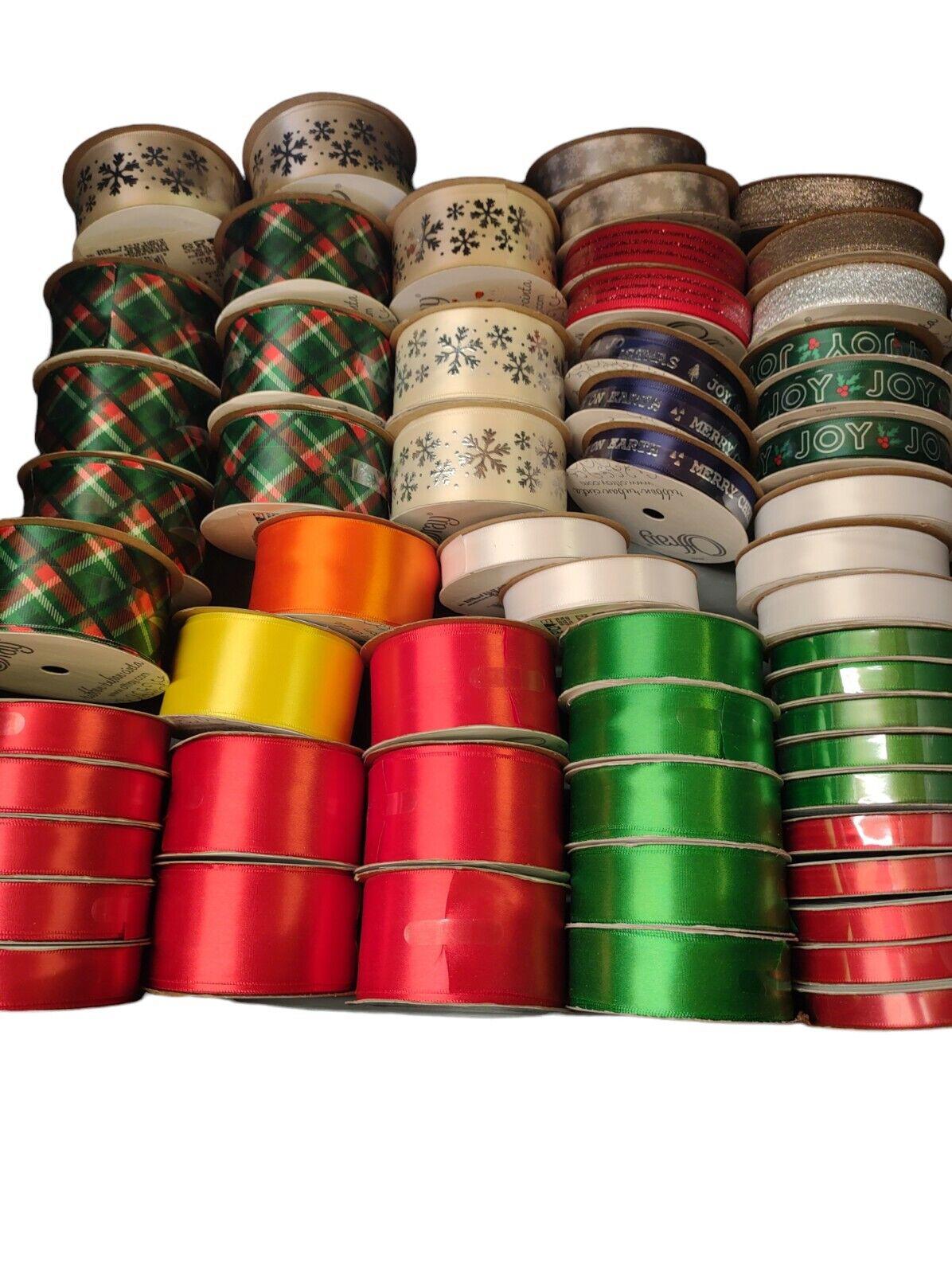 Colorful ribbon collection featuring red, green, and gold ribbons for crafting and decorating.