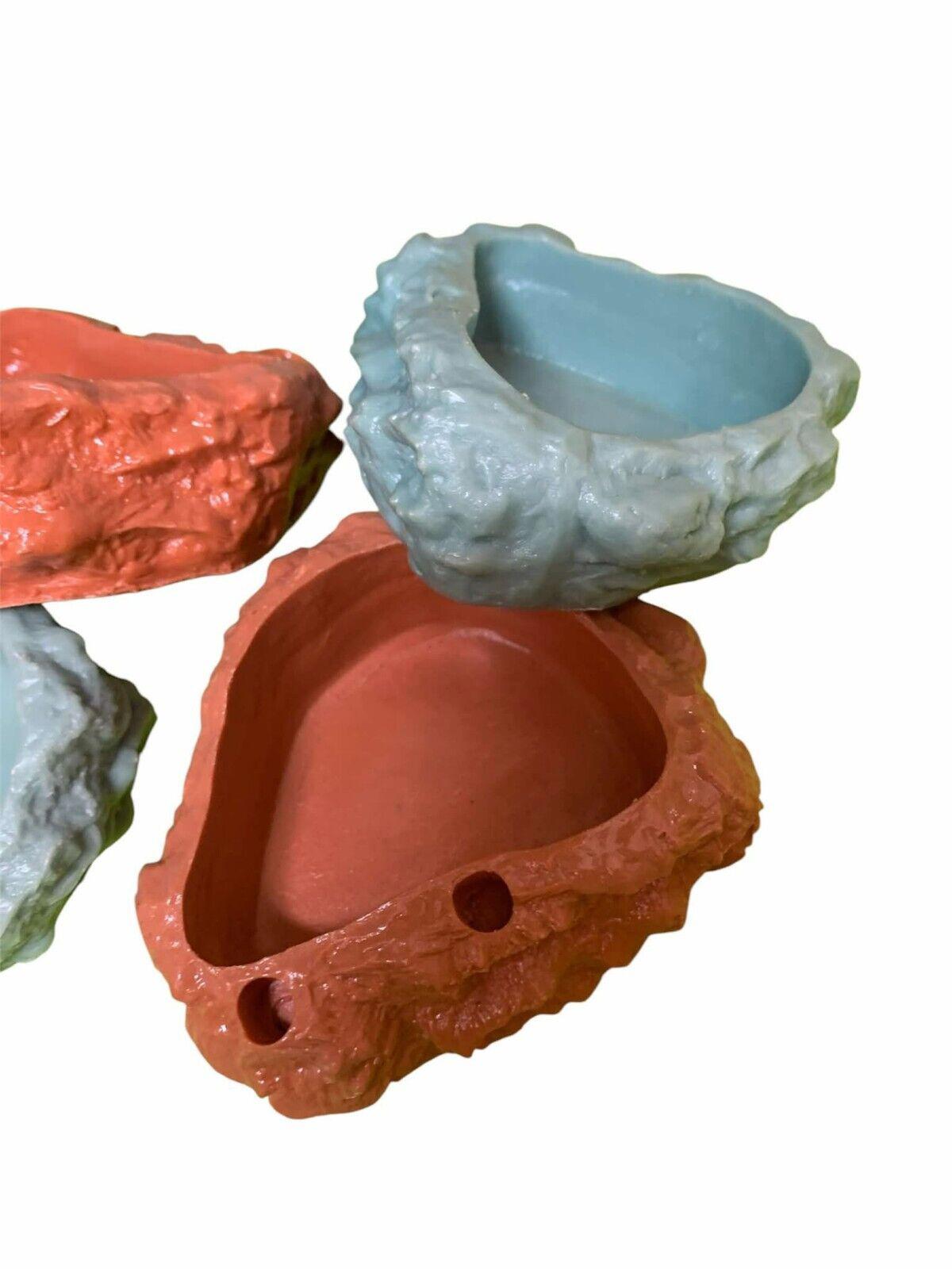 Colorful rock-shaped planters in coral and blue, perfect for indoor plants.