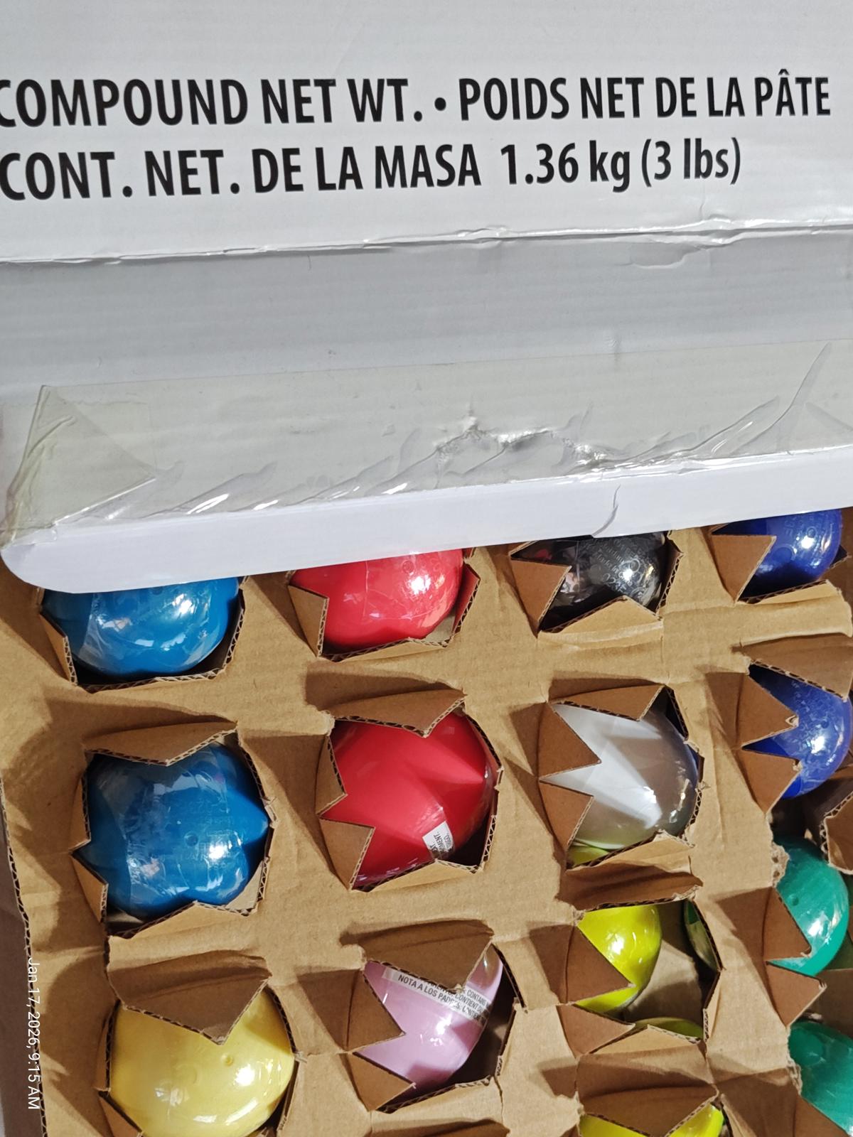 Colorful star-shaped candies in a cardboard box, featuring various vibrant colors.