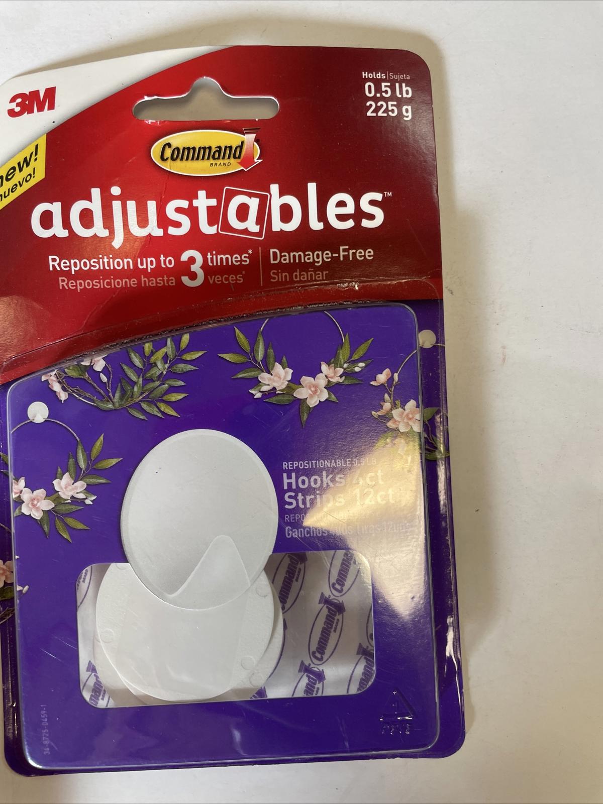 Command Adjustables hooks for damage-free hanging, featuring repositionable design and floral packaging.