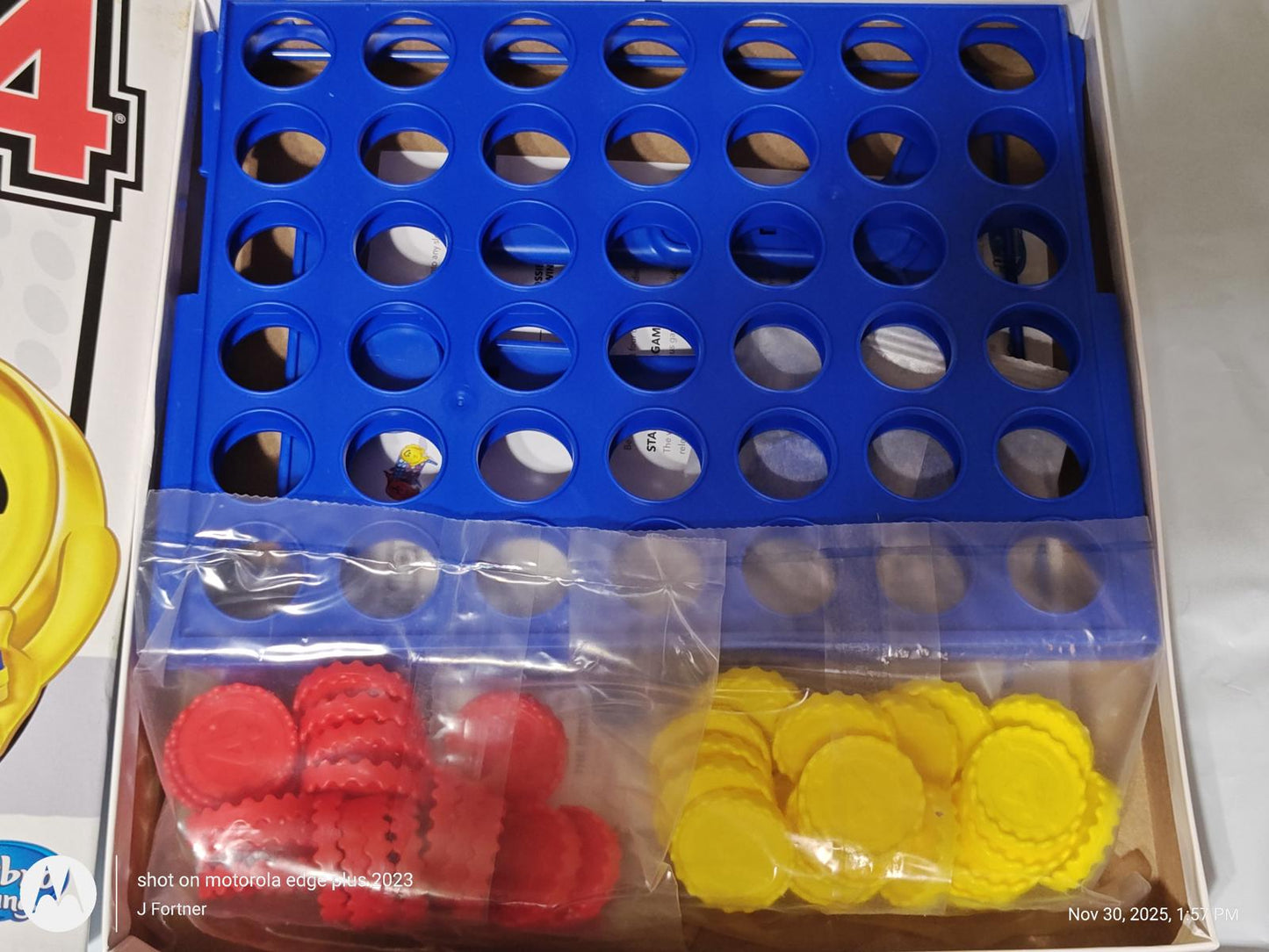 Connect Four game board with blue grid and red, yellow discs.