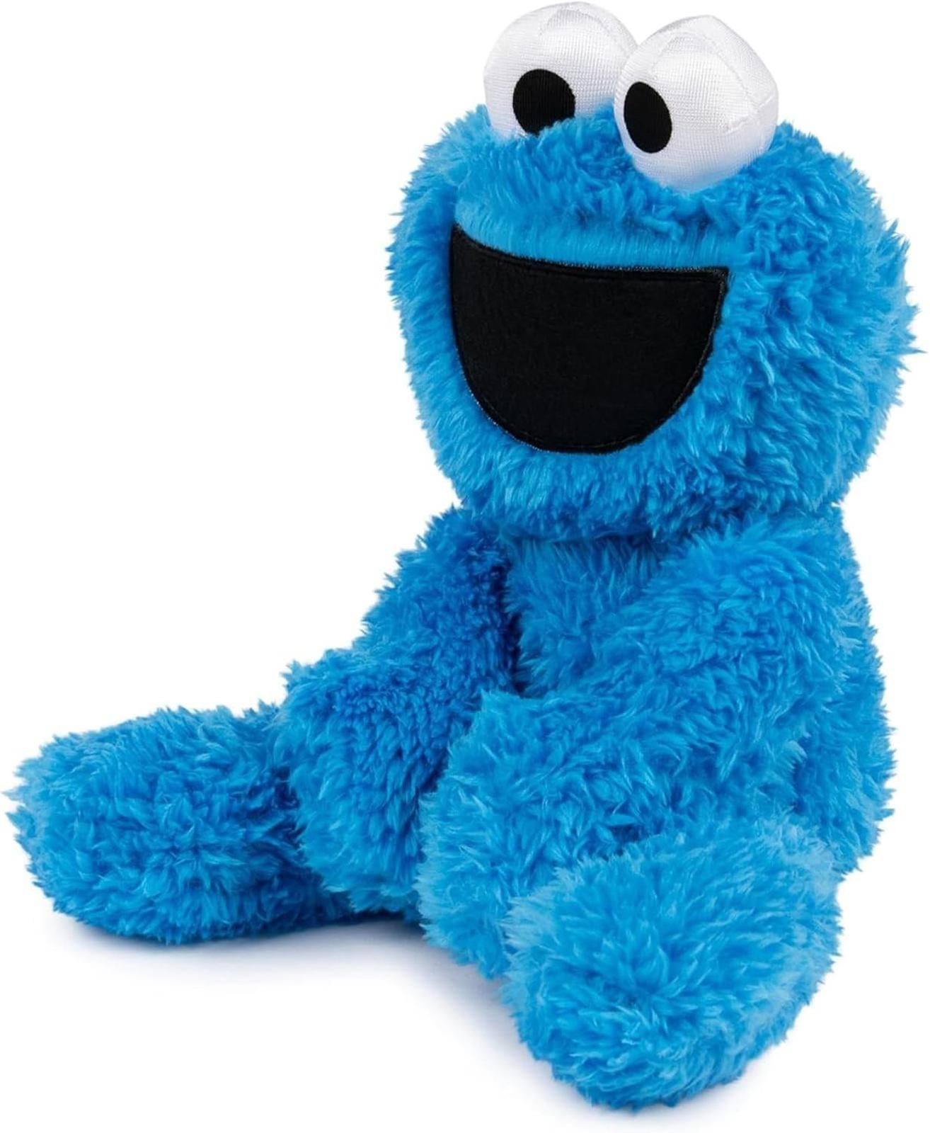 Cookie Monster plush toy in bright blue color with large eyes and a big smile.