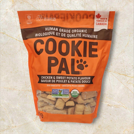 Cookie Pal chicken and sweet potato flavor dog treats in an orange bag.