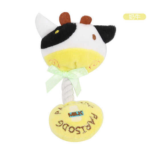Cow plush rattle toy with a yellow base and green bow, perfect for infants.