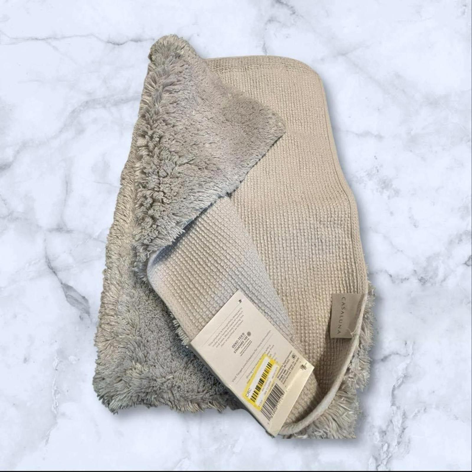 Cozy Beige Bath Mat with Soft Texture and Non-Slip Backing.