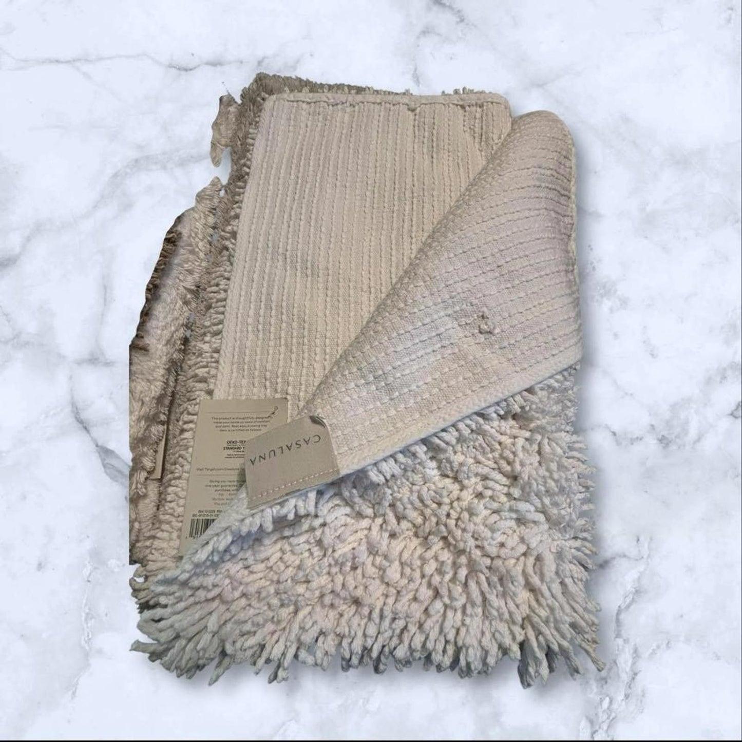 Cozy Beige Throw Blanket featuring textured fabric and fringed edges.