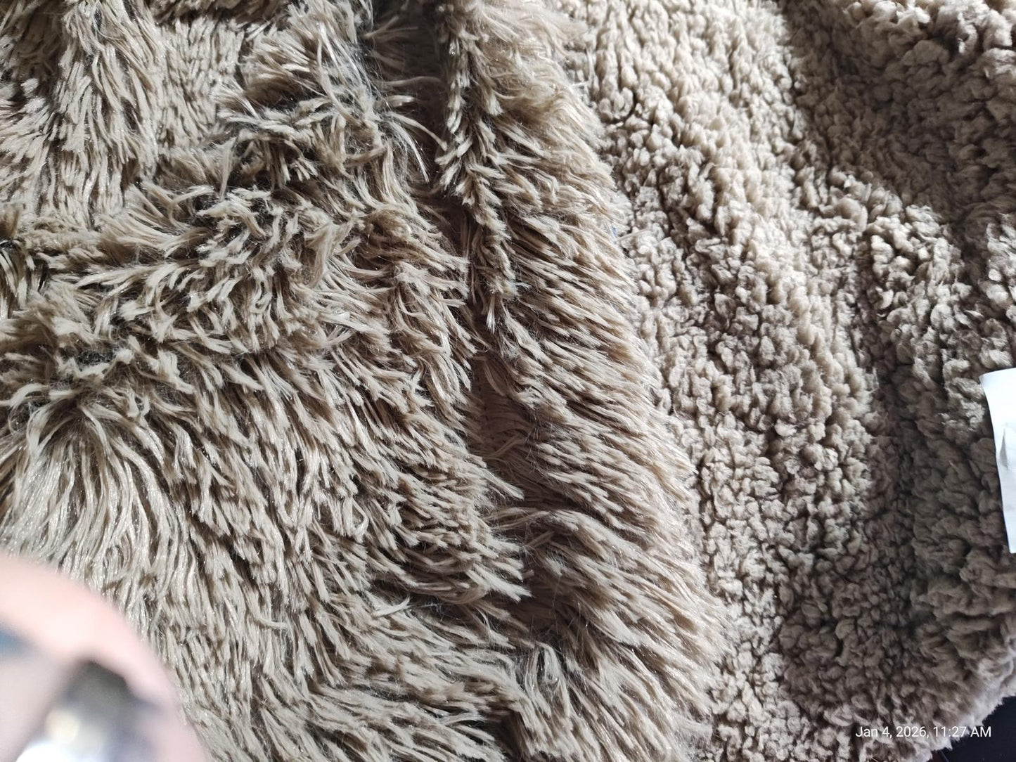 Cozy Faux Fur Blanket in soft beige color with fluffy texture.