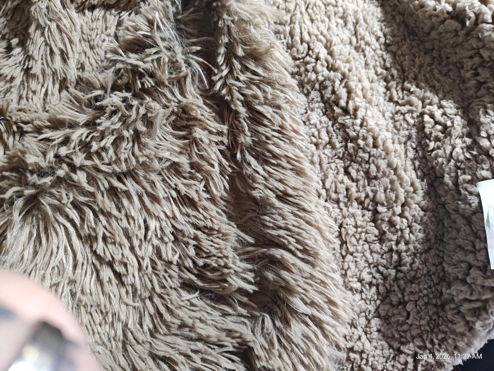 Cozy Faux Fur Blanket in soft beige color with fluffy texture.