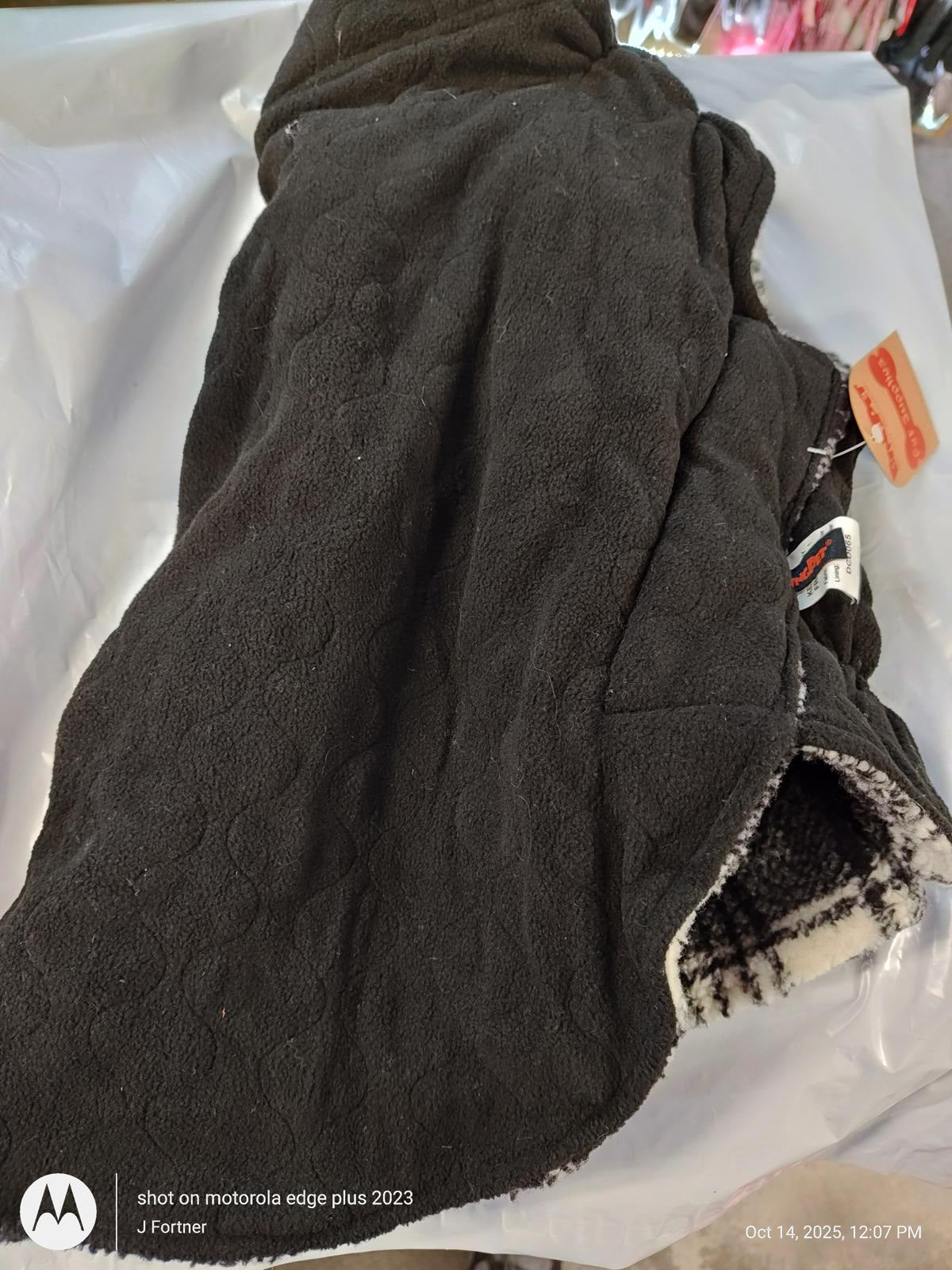 Cozy black fleece blanket featuring a textured pattern and soft lining.