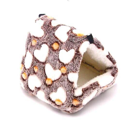 Cozy pet bed with heart pattern, soft and plush for small animals.
