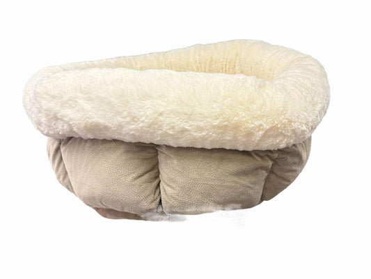 Cozy pet bed with plush cream lining and soft beige exterior for ultimate comfort.