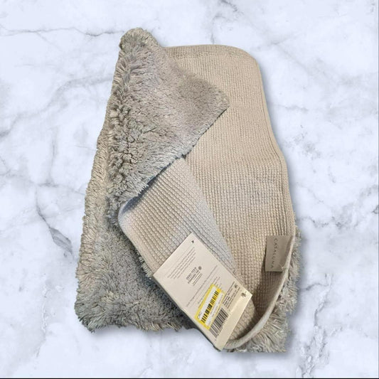 Cozy Beige Bath Mat with Soft Texture and Non-Slip Backing.
