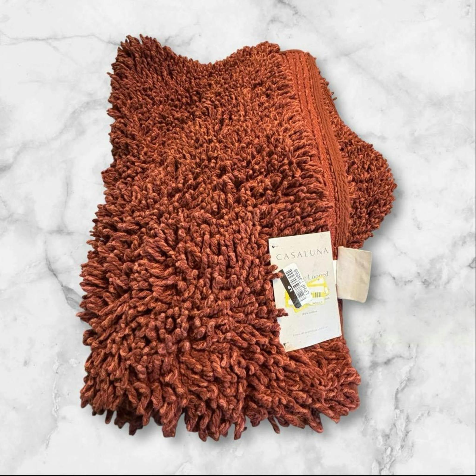 Cozy terracotta shaggy throw blanket with soft texture and tag.