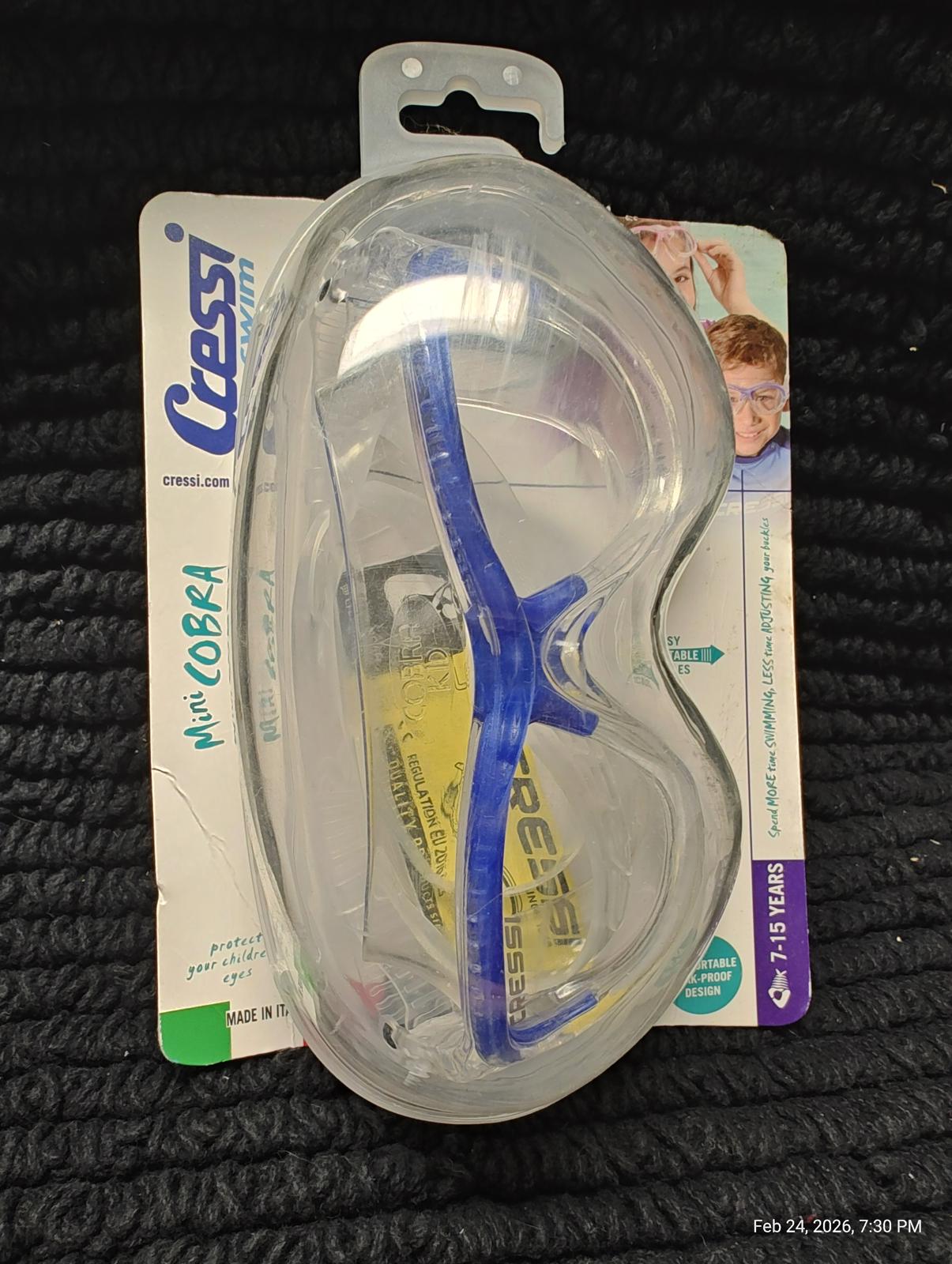 Cressi Mini Cobra swimming goggles with blue accents in packaging.
