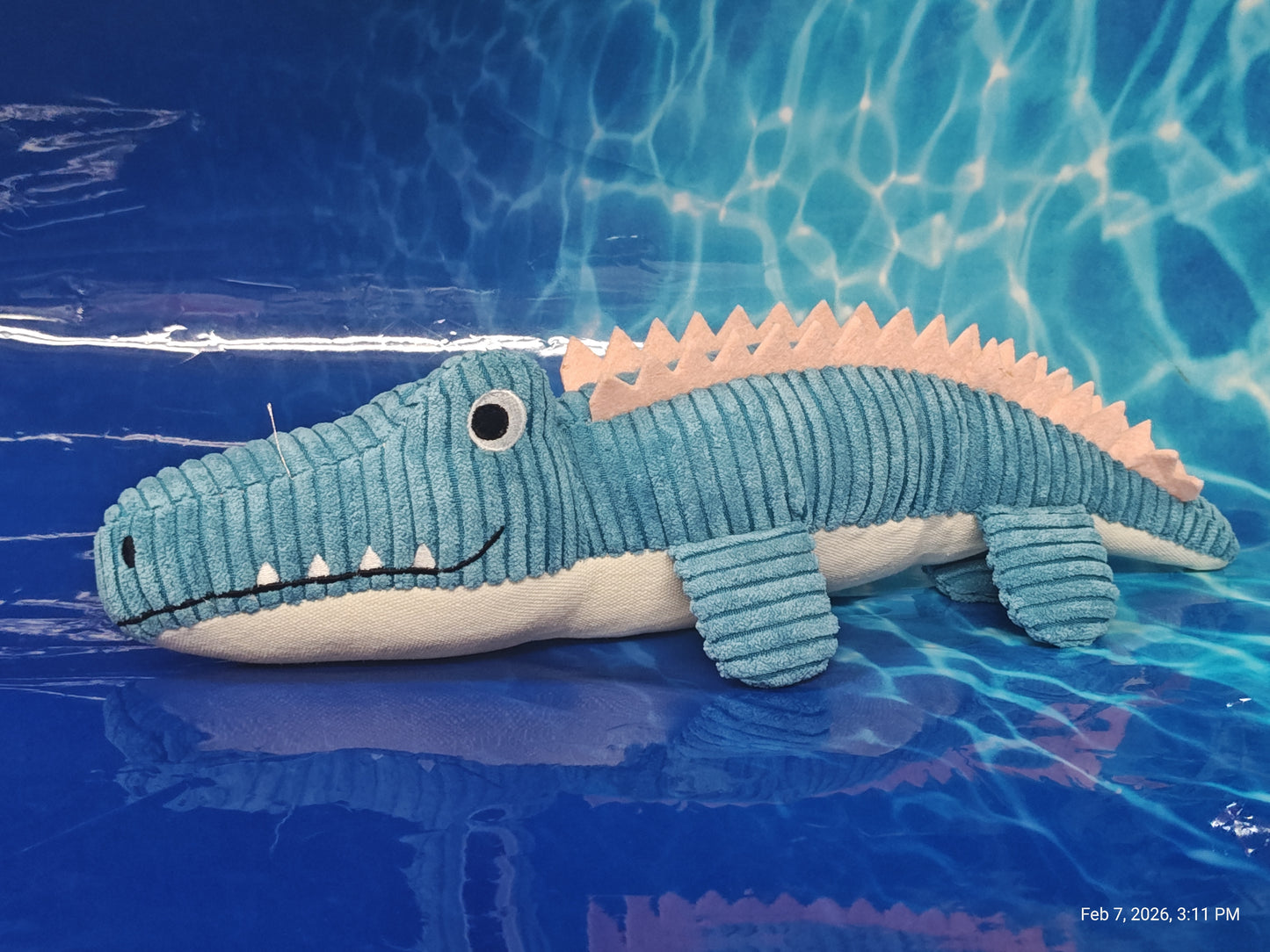 Crocodile Plush Toy featuring a blue and pink design with textured fabric.