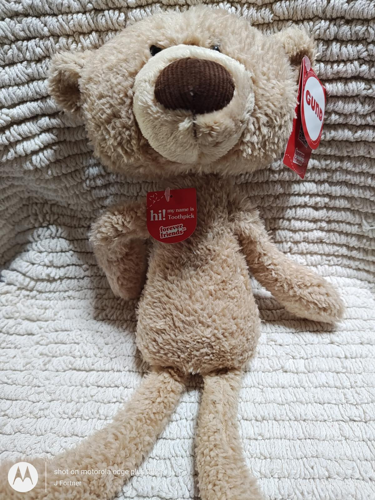 Cuddle Bear plush toy with soft fur and a friendly expression, perfect for hugs.