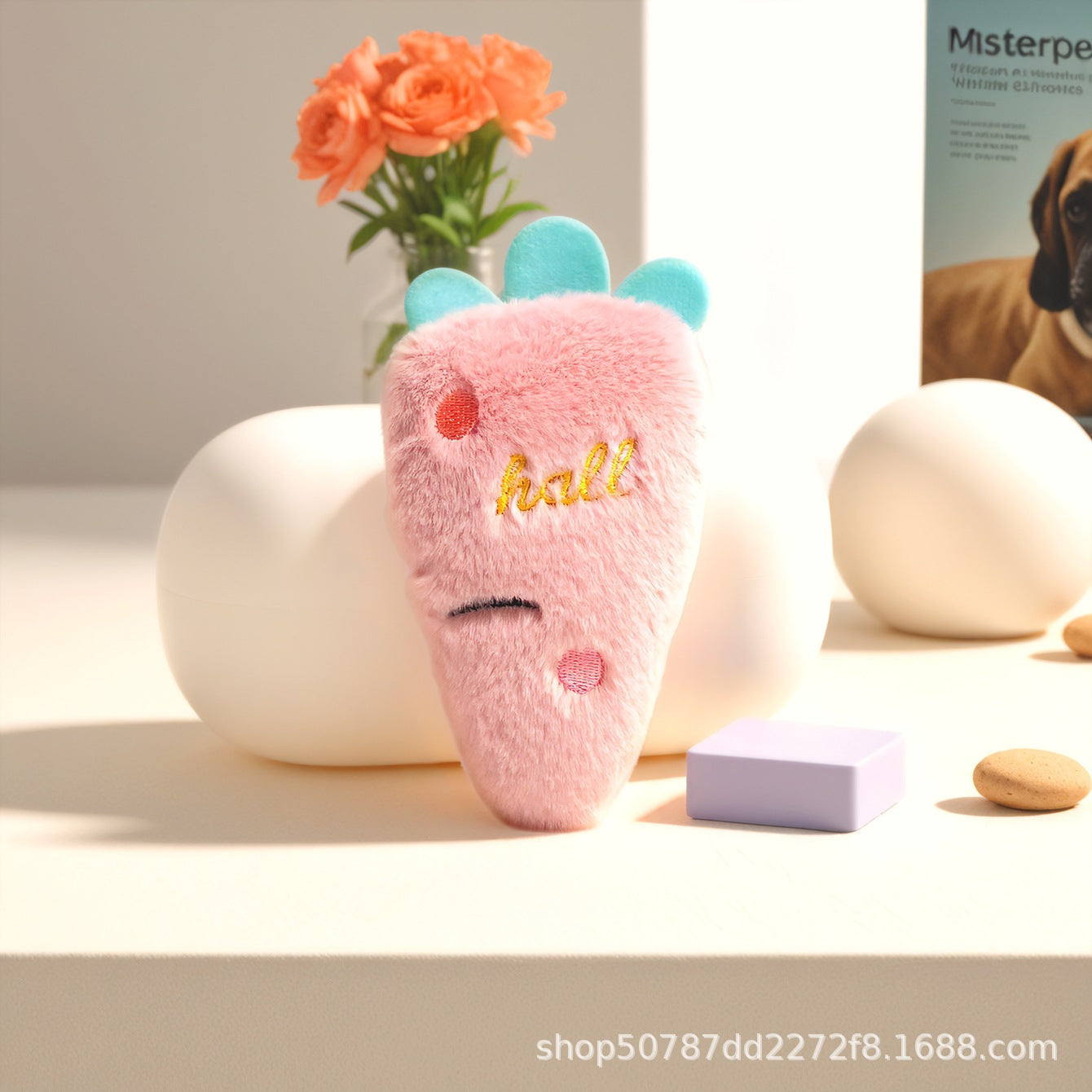 Cute pink plush carrot toy with blue top and smiley face for pets.