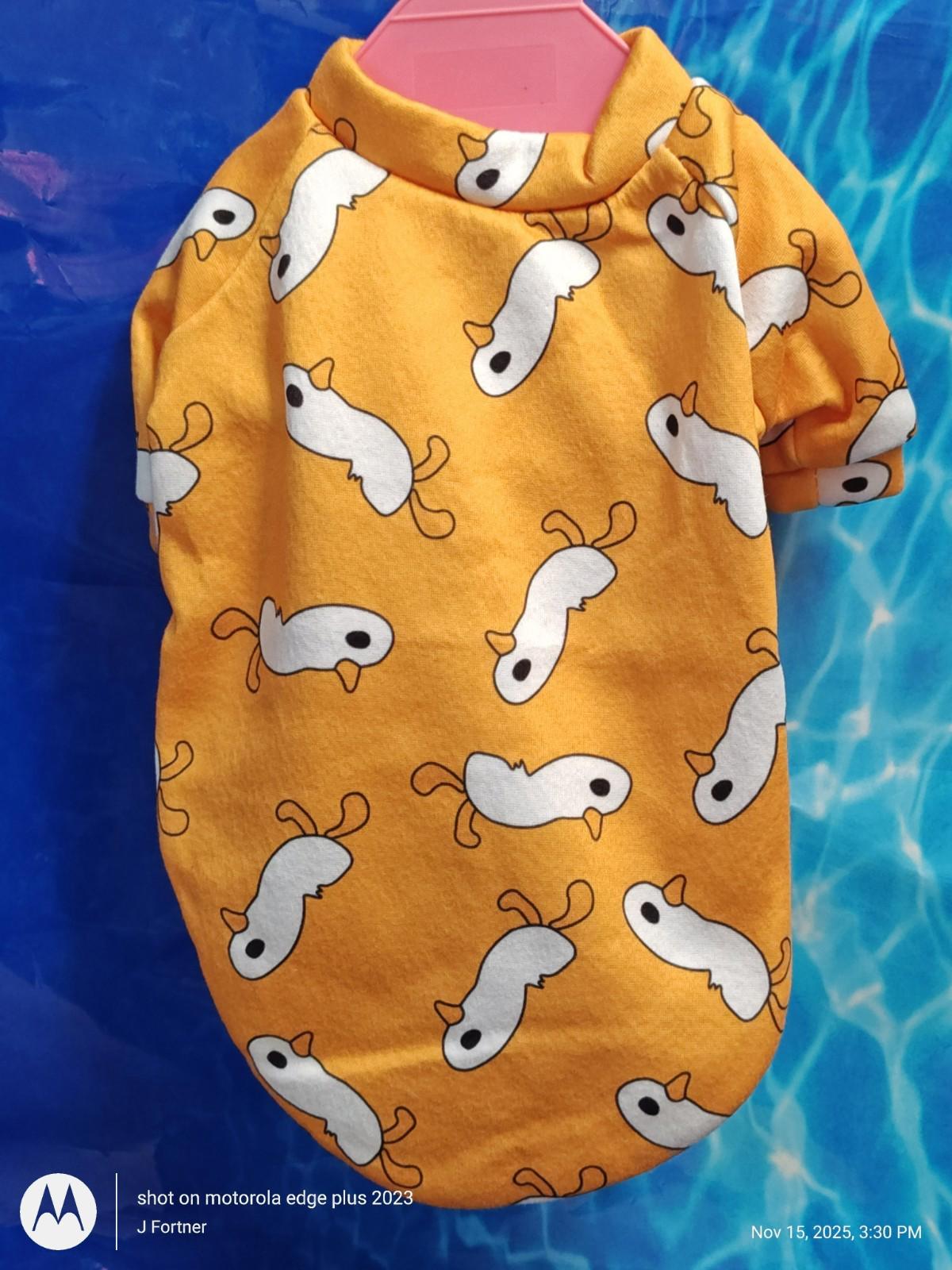 Cute yellow dog shirt featuring playful white fish patterns, perfect for pets.