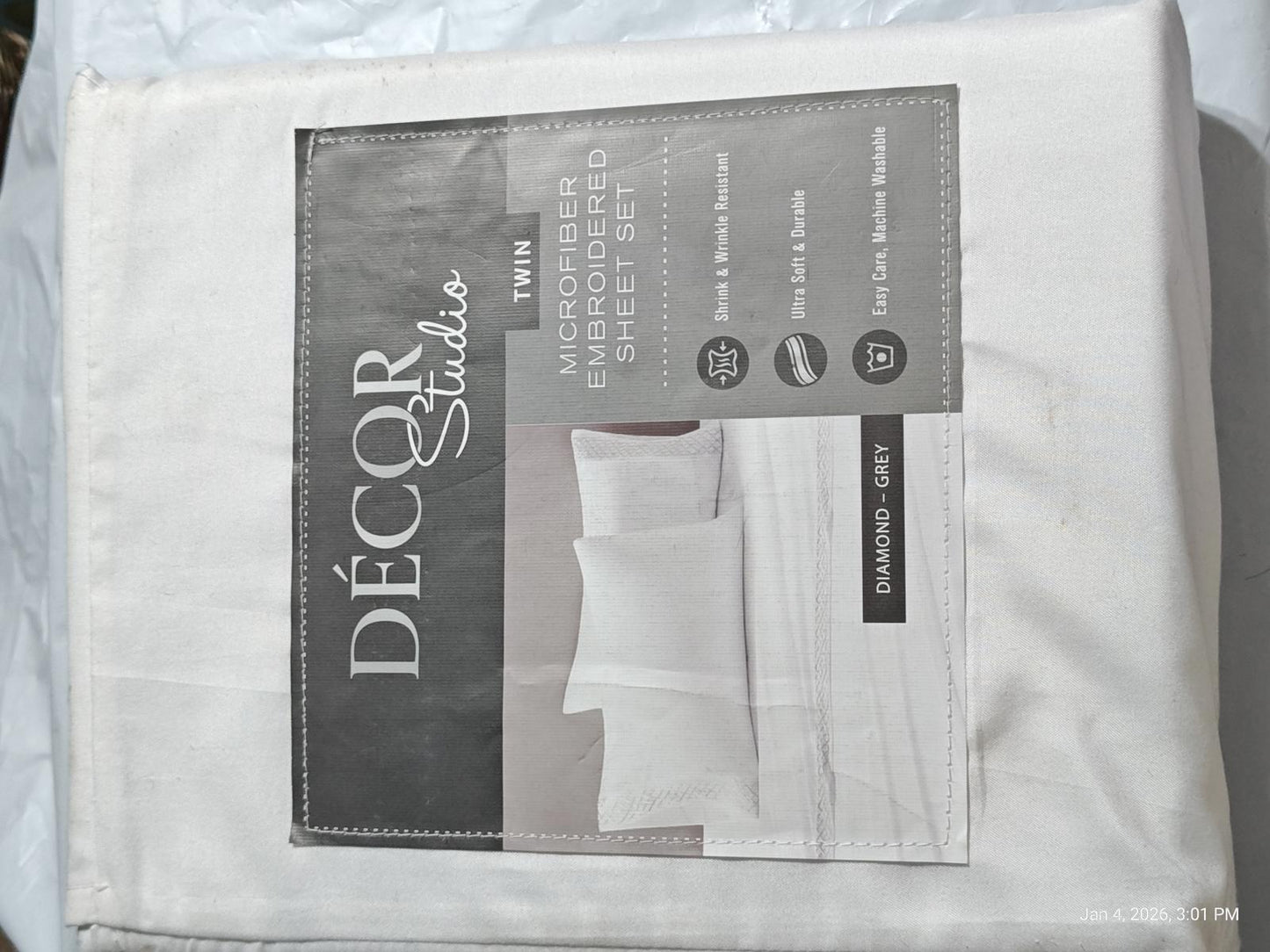Décor Studio white bed sheet set packaging with pillowcases visible.
