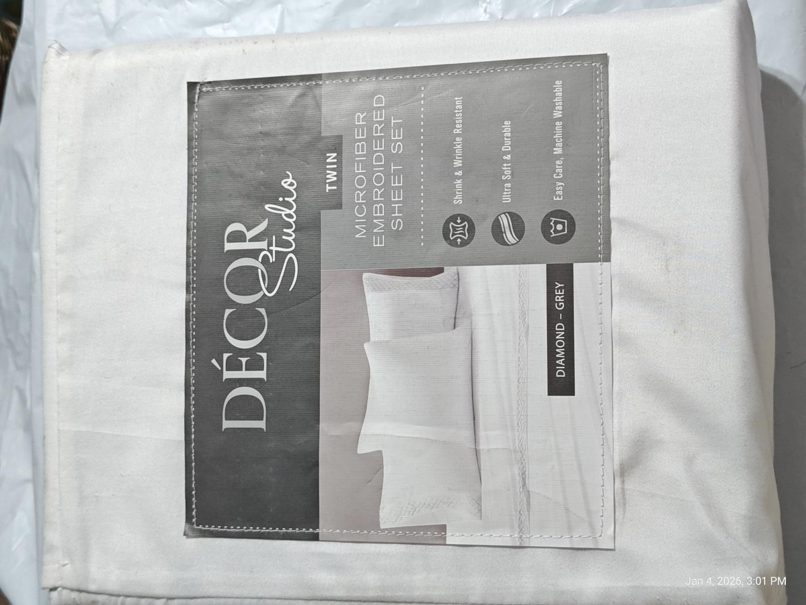 Décor Studio white bed sheet set packaging with pillowcases visible.